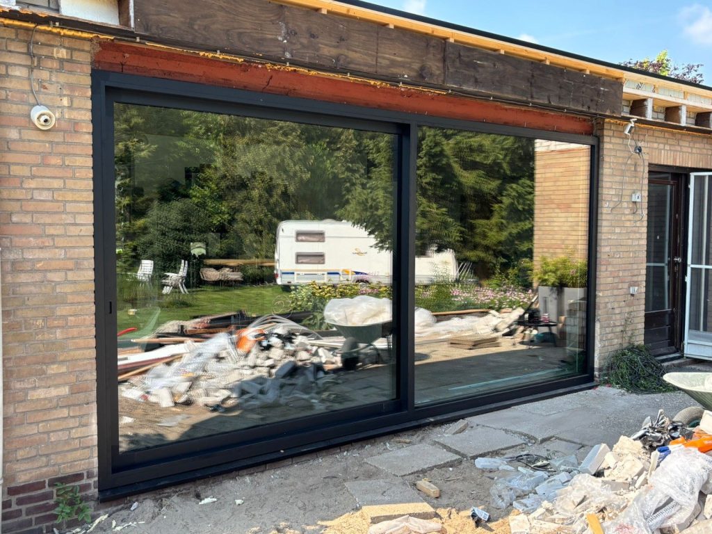 Brede aluminium schuifpui in de achtergevel van de woning in Hoogblokland